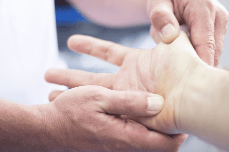 Close up of a hand being massaged and or examined 