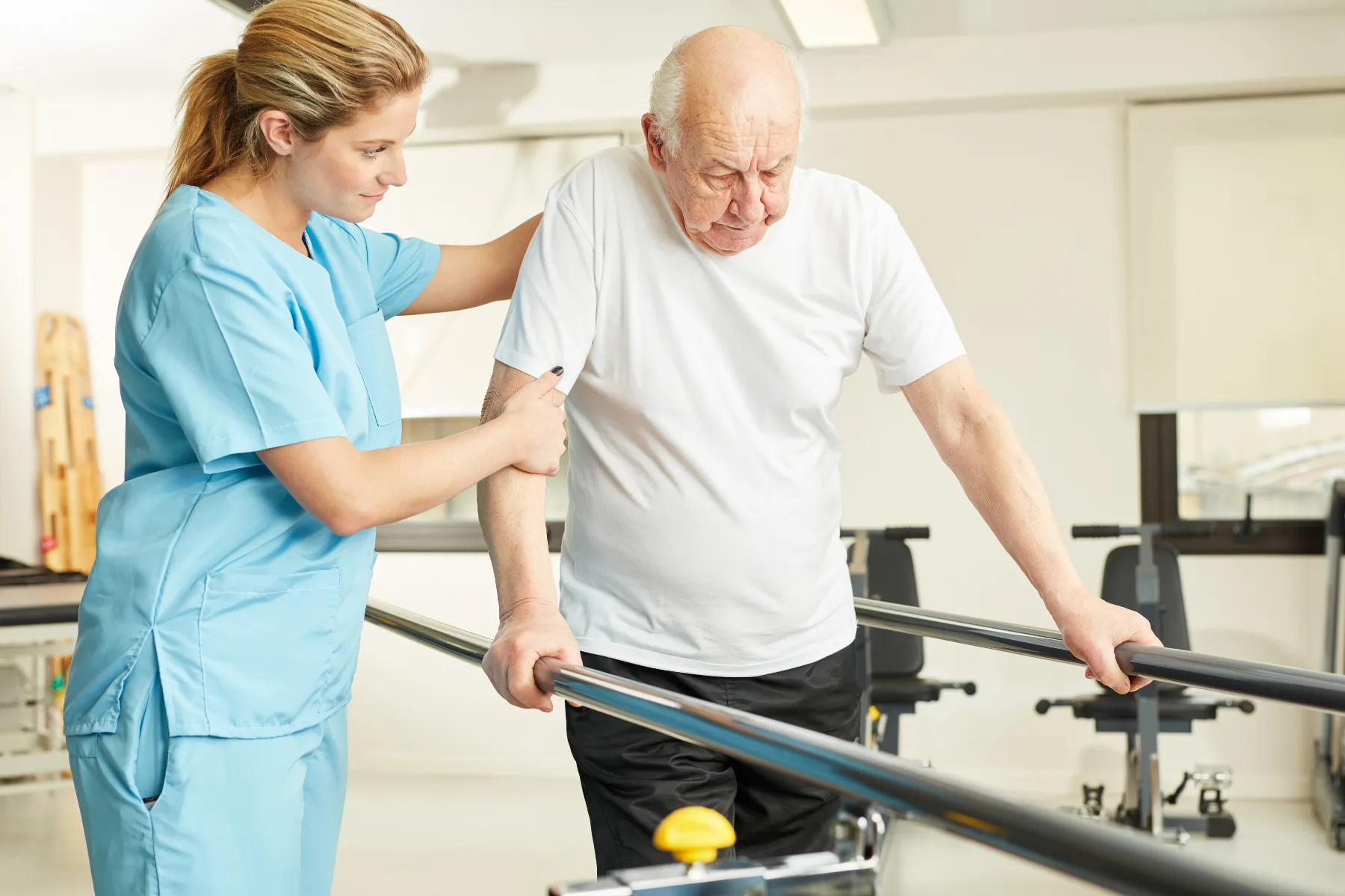 Woman helping man with physical therapy
